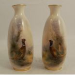 A pair of Royal Worcester vases, decorated to the front with pheasants in landscape by Jas