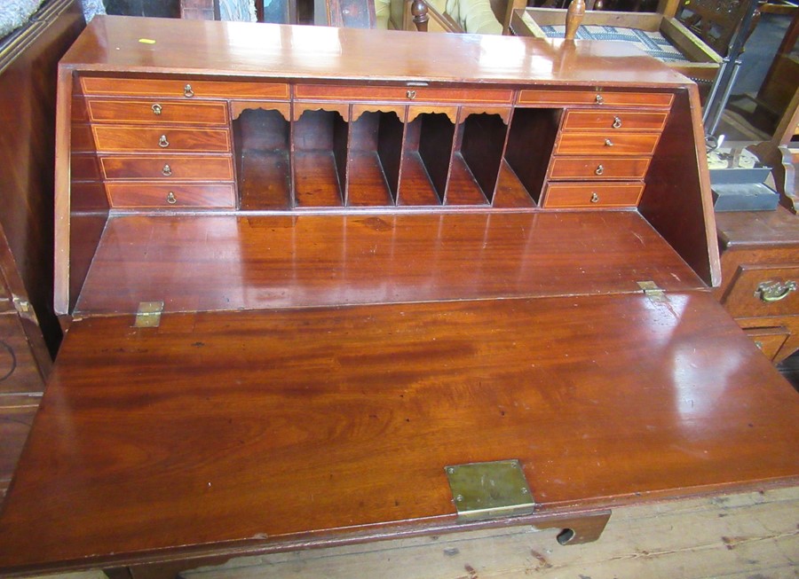 A 19th century mahogany bureau, the interior fitted with drawers and pigeon holes, over two short - Image 2 of 2