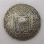 A Charles IIII eight reales coin, with indistinct countermark
