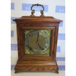 An oak cased  mantle clock, the square dial with silvered chapter ring, the striking movement