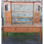 An oak dresser, the top with opened shelves and two cupboards, the base fitted with three frieze