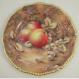 A Royal Worcester plate, decorated with fruit to a mossy background by P Love, dated 1954,