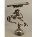 A silver plated mythical beast stand, the circular top supported on a horse type creature set with