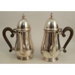 A pair of silver Queen Anne style coffee pots, with side wooden scroll handles, London 1908,