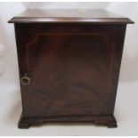 A 19th century mahogany coin cabinet, having a single door opening to reveal nine trays, with