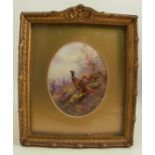 A Royal Worcester oval porcelain plaque, painted with pheasants in a landscape with village beyond