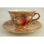 A Royal Worcester cup and saucer, decorated with fruit to a mossy background by P Love, dated 1952/