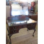 A mahogany dressing table, with shaped rectangular mirror, the base fitted with five drawers, raised