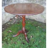A 19th century oak tripod table, the circular top raised on a turned column, on three outswept
