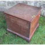 An oak box, with hinged rising lid, raised on bracket feet, 19.75ins x 19ins, height 19ins