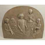 A metal plaque, with embossed decoration of children playing percussion instruments, 13ins x 17.