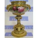 A Royal Worcester vase, with pierced rim, mask handles, the body decorated with roses, raised on a