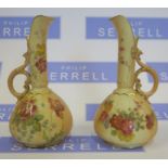 A pair of Royal Worcester blush ivory ewers, decorated with flowers, shape number 1143, dated