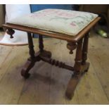A 19th century mahogany stool, with tapestry seat, raised on ringed columns with a twist support,