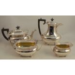 A silver four piece tea and coffee set, with gadrooned edge with flower heads to the corners,
