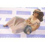 A Lladro figure, Noella, 2251, model of a girl reclining, with a bird on her hand, height 8ins