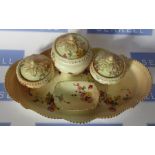 A Royal Worcester blush ivory dressing table set, decorated with flowers, comprising an oval tray,