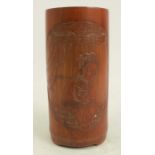 A bamboo brush pot, carved with a woman and character marks, height 4.75ins