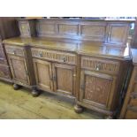An oak sideboard, fitted with two cupboards to the back, the base fitted with three drawers over