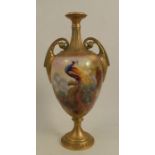 A Royal Worcester two handled vase, decorated with a peacock in a tree, signed J Southall, shape