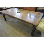 An oak wind out dining table, with two leaves, raised on turned legs, 94ins x 47ins, height 30ins,