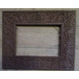 A rectangular wall mirror, the carved wooden frame decorated with leaves, mirror size 12ins 8.5ins