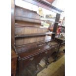 An Antique oak dresser, the rack back fitted with short drawers, the base fitted with three