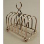 A silver seven bar toast rack, raised on ball feet, Sheffield 1921, weight 10oz