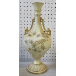 A Royal Worcester two handled vase, having bud finials, decorated with gilt foliage, date code for