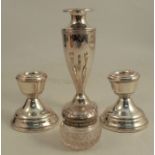A pair of dwarf hallmarked silver candlesticks, together with a hallmarked silver spill vase and a