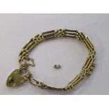 A gold gate link bracelet with shield shaped clasp