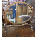 A mahogany framed dressing table mirror, of oval form, height 21ins, width 22ins