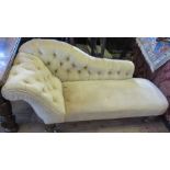 A Victorian chaise longue, with button back shaped rail and scroll end, raised on turned legs,
