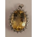 A citrine and diamond cluster pendant, the oval cut, measuring approximately 2.2cm by 1.57cm by 1.
