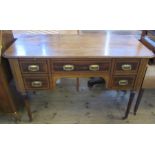 A 19th century mahogany Maple & Co desk, with inlaid decoration, fitted with five drawers around the