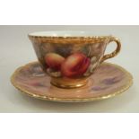 A Royal Worcester cup and saucer, decorated with fruit to a mossy background by P Love, dated