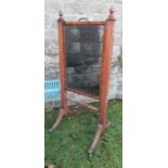 A Regency style mahogany cheval mirror, the rectangular mirror plate with reeded supports, on reeded