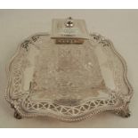 A silver desk stand, of shaped square form, with bead edge, pierced border and engraved