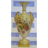 A Royal Worcester blush ivory vase, with mask handles, the body decorated with flowers, raised on