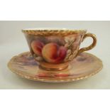 A Royal Worcester cup and saucer, decorated with fruit to a mossy background by P Love, dated