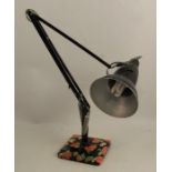 An angle poise lamp, stamped Herbert Terry and Sons Ltd, Redditch, raised on a stepped base