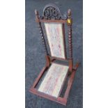 A faux rosewood folding chair, with carved decoration and upholster panels