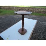 A small occasional table, the circular top inlaid with a figure in a wagon pulled by oxen,