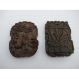 Two oriental carved horn plaques, one decorated with a figure, the other with flowers, both with