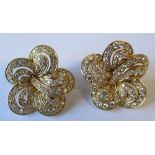 A pair of diamond cluster earrings, in unmarked yellow metal, of cinquefoil outline, each set with