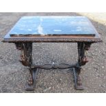A marble topped mahogany table, the rectangular marble set in to a carved frame, raised on end