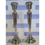 A pair of hallmarked silver candlesticks, height 10ins