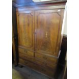A 19th century mahogany linen press, the pair of cupboard doors with inlaid decoration, opening to