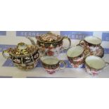 A Royal Crown Derby Imari pattern tea pot, together with a covered sugar bowl, three cups, a bowl,