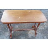 An Edwardian mahogany table, of rectangular form, on turned end supports united by a stretcher,